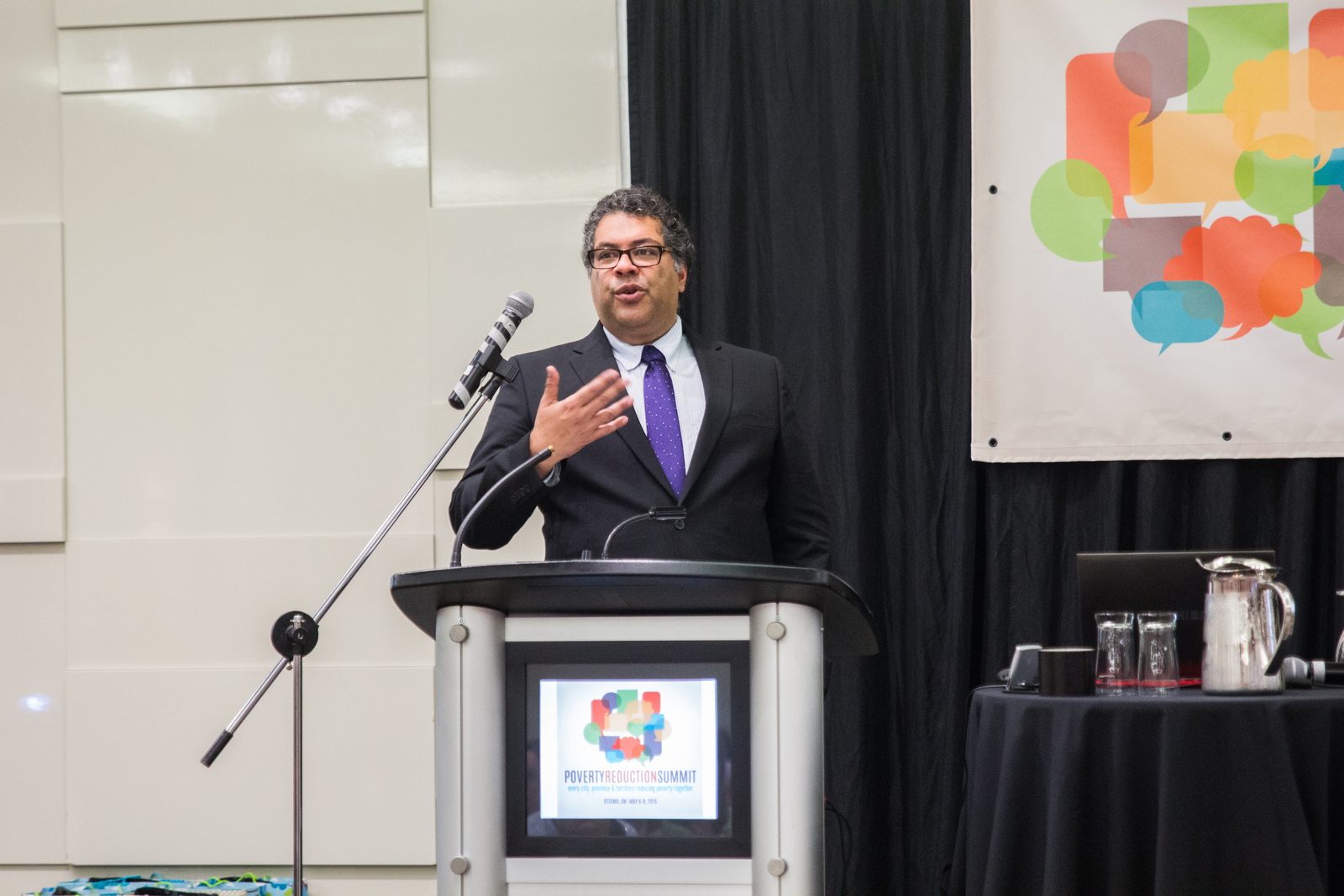 Naheed Nenshi at a podium