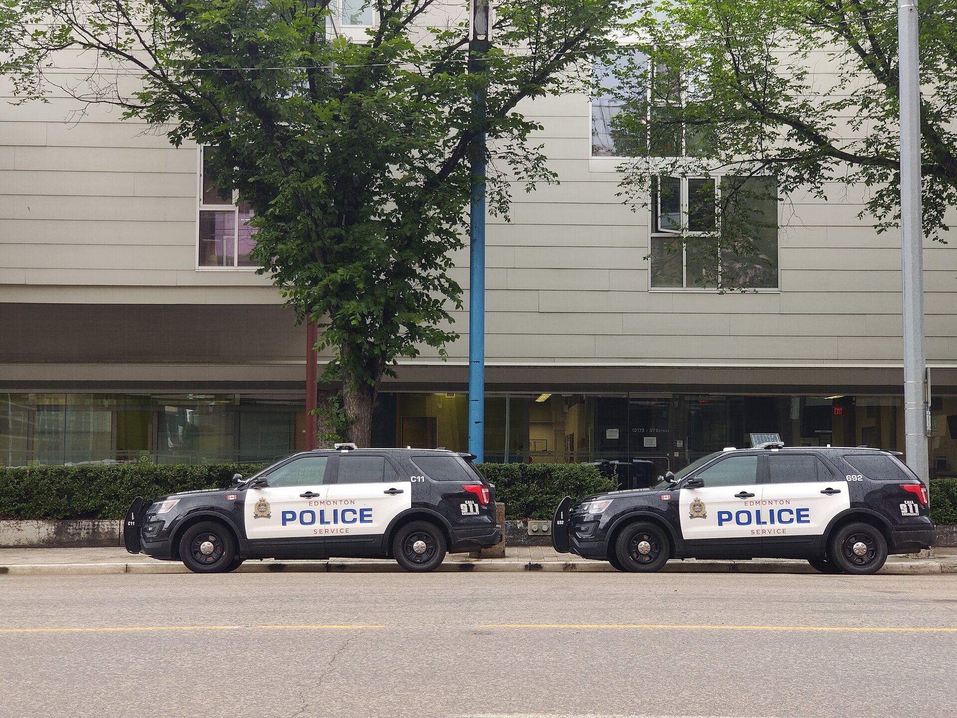 Two Edmonton Police Service cruisers parked on a downtown street